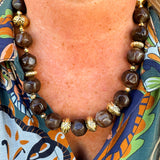 Necklace with brown beads and gold accents.