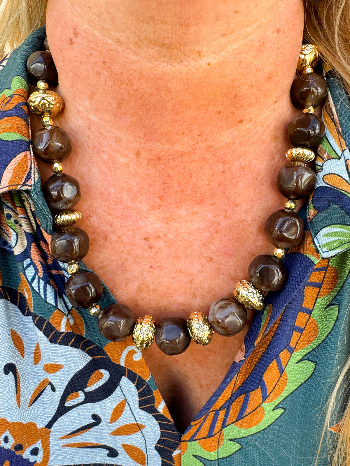 Necklace with brown beads and gold accents.