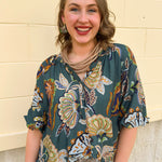 Teal abstract print top with split neckline and 3/4 banded sleeves in navy, light blue, and mocha tones.