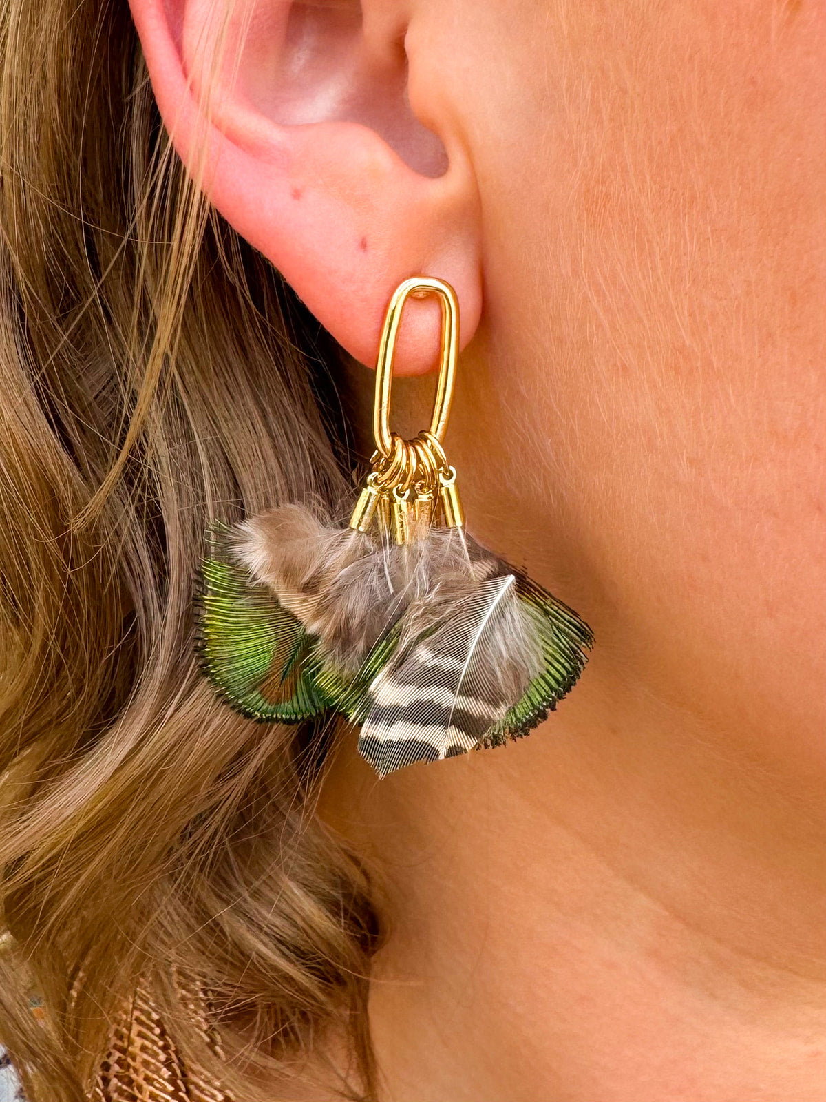 Mallard-colored feather tassel statement earrings with earthy greens and browns, displayed on a neutral background