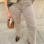Cream-taupe straight leg jeans with high rise and clean hem finish.