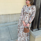 Brown and cream floral midi dress with cinched waist and 3/4 sleeves