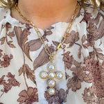 Gold textured oval chain necklace with flat pearl-beaded cross pendant.