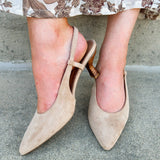 Beige suede slingback pumps with pointed toe and mid stacked heel.