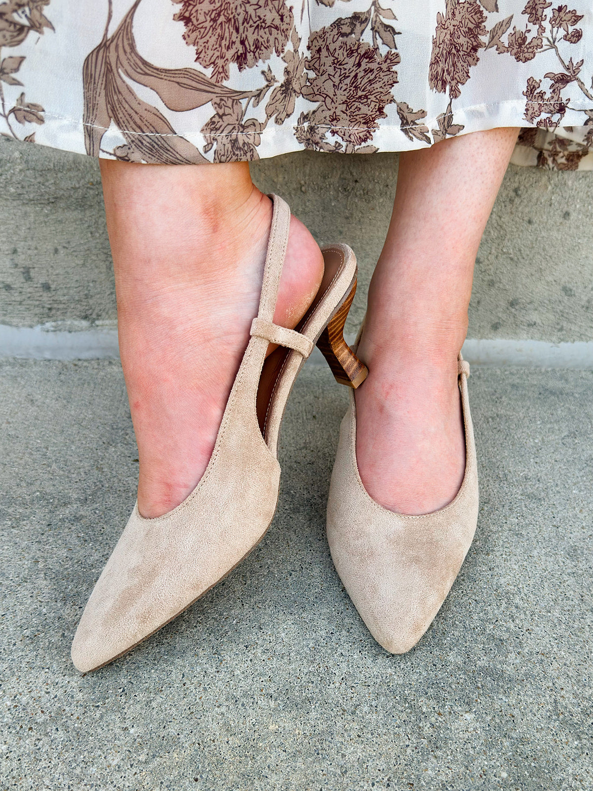 Beige suede slingback pumps with pointed toe and mid stacked heel.