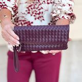 Merlot clutch with gold hardware and wrist strap