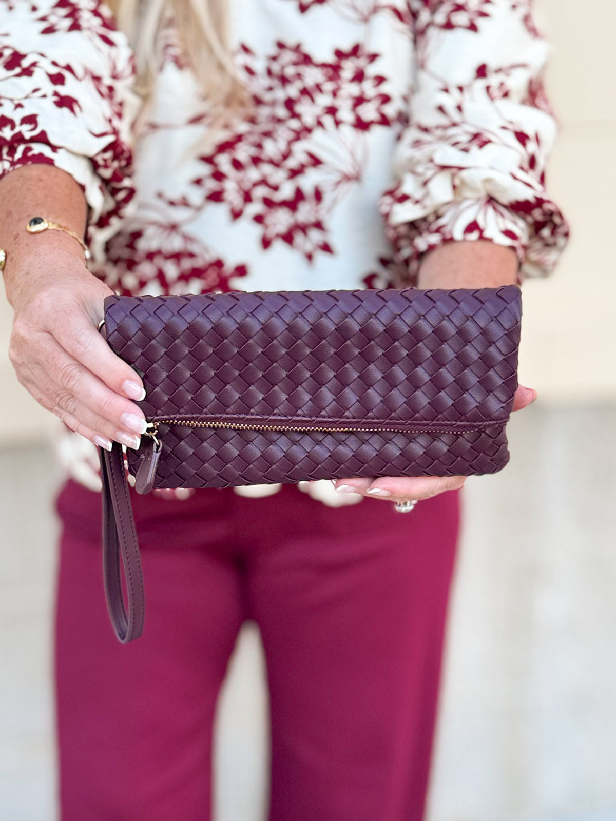 Merlot clutch with gold hardware and wrist strap