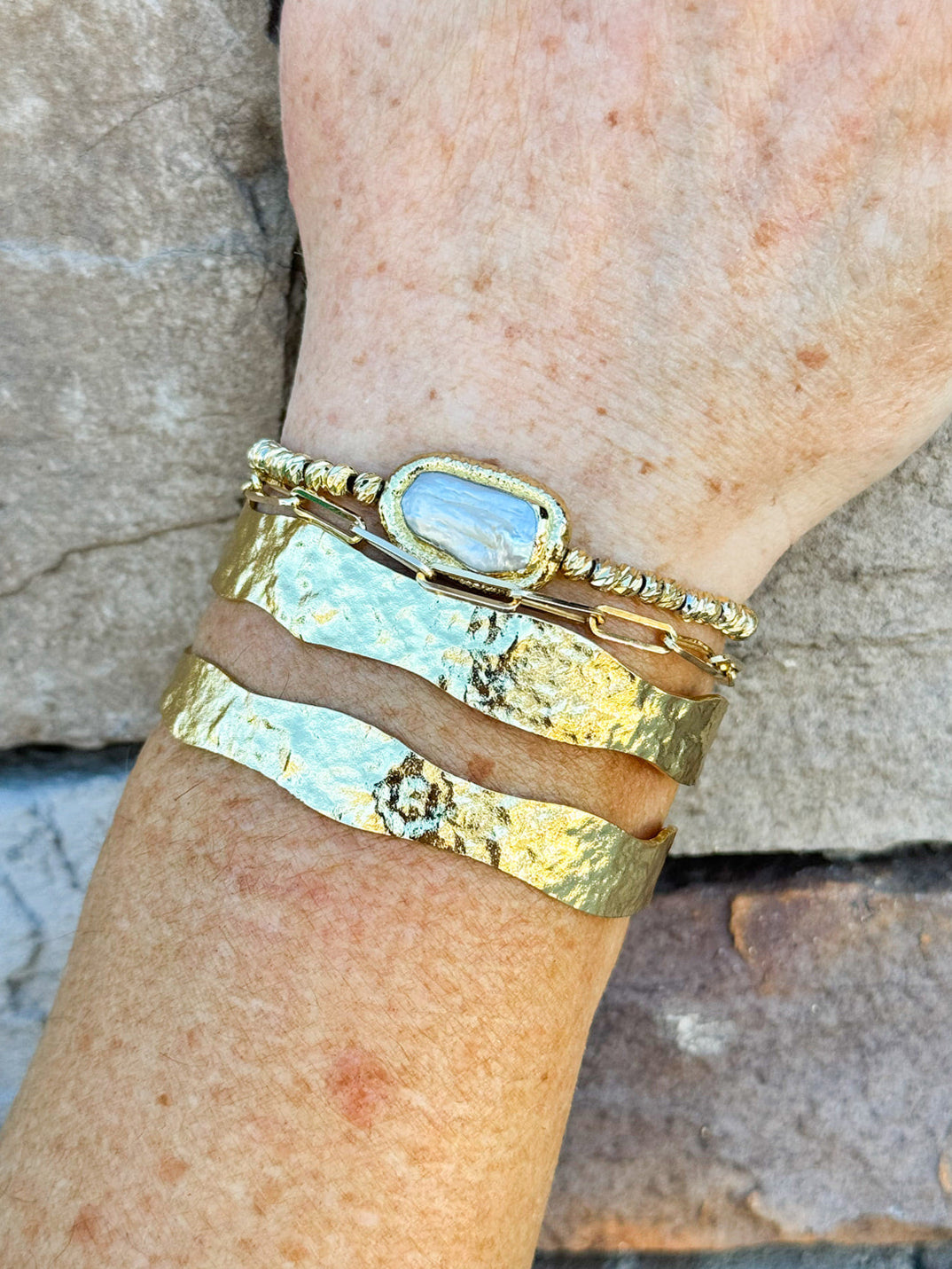 Double gold-plated open cuff bracelet with sleek, minimalist design.