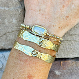 Double gold-plated open cuff bracelet with sleek, minimalist design.
