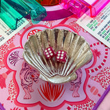 Silver seashell-shaped Mahjong dice dish holding two pink Mahjong dice.