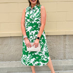 Green and white floral collared midi dress with button front, sleeveless design, and contrast piping—lightweight and polished
