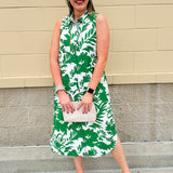 Green and white floral collared midi dress with button front, sleeveless design, and contrast piping—lightweight and polished