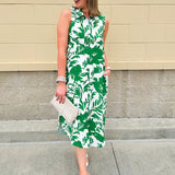 Green and white floral collared midi dress with button front, sleeveless design, and contrast piping—lightweight and polished