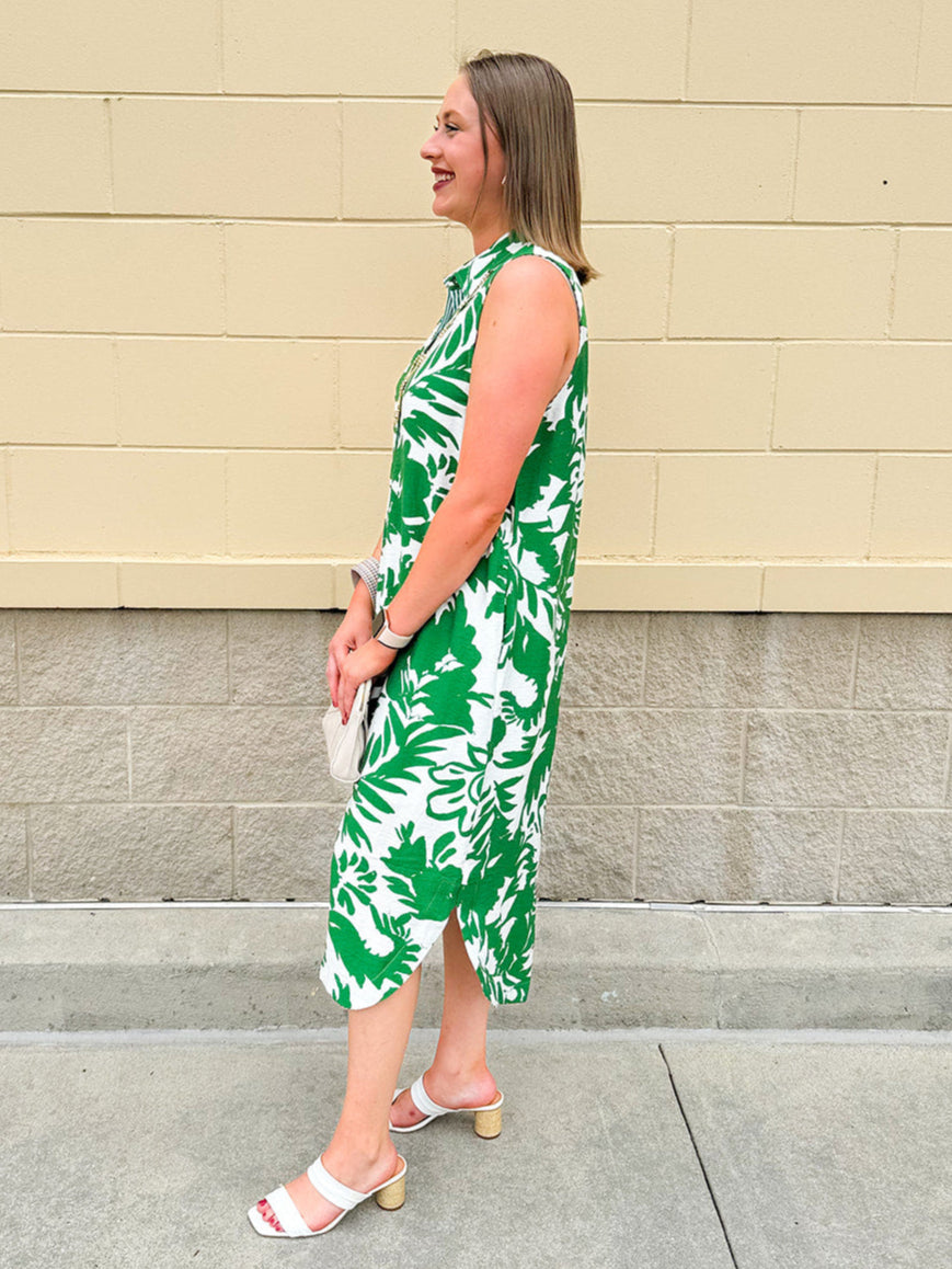 Green and white floral collared midi dress with button front, sleeveless design, and contrast piping—lightweight and polished