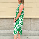 Green and white floral collared midi dress with button front, sleeveless design, and contrast piping—lightweight and polished