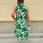 Green and white floral collared midi dress with button front, sleeveless design, and contrast piping—lightweight and polished