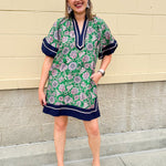 Green and pink floral paisley pullover mini dress with navy high neck, bubble sleeves, side slits, and pockets—lightweight woven fabric