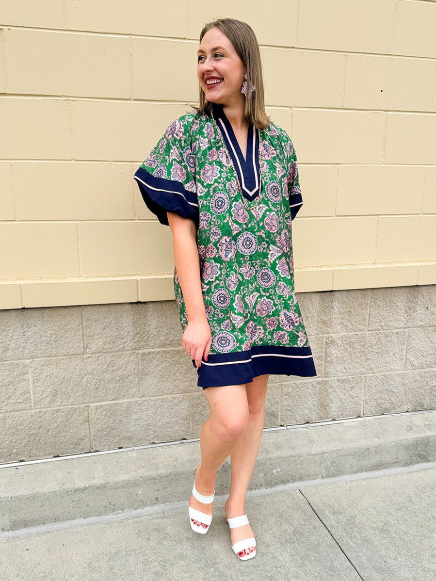 Green and pink floral paisley pullover mini dress with navy high neck, bubble sleeves, side slits, and pockets—lightweight woven fabric