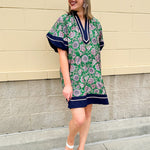 Green and pink floral paisley pullover mini dress with navy high neck, bubble sleeves, side slits, and pockets—lightweight woven fabric