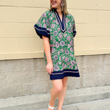 Green and pink floral paisley pullover mini dress with navy high neck, bubble sleeves, side slits, and pockets—lightweight woven fabric