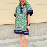 Green and pink floral paisley pullover mini dress with navy high neck, bubble sleeves, side slits, and pockets—lightweight woven fabric