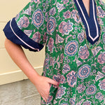 Green and pink floral paisley pullover mini dress with navy high neck, bubble sleeves, side slits, and pockets—lightweight woven fabric