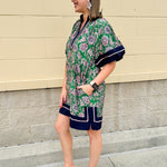 Green and pink floral paisley pullover mini dress with navy high neck, bubble sleeves, side slits, and pockets—lightweight woven fabric