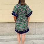 Green and pink floral paisley pullover mini dress with navy high neck, bubble sleeves, side slits, and pockets—lightweight woven fabric