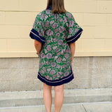 Green and pink floral paisley pullover mini dress with navy high neck, bubble sleeves, side slits, and pockets—lightweight woven fabric