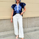 Navy embroidered flutter sleeve top with multicolor appliqué and V-neckline—lightweight and versatile for everyday wear