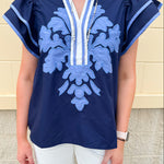 Navy embroidered flutter sleeve top with multicolor appliqué and V-neckline—lightweight and versatile for everyday wear