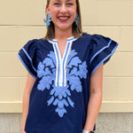 Navy embroidered flutter sleeve top with multicolor appliqué and V-neckline—lightweight and versatile for everyday wear