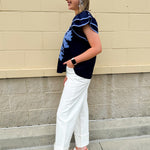 Navy embroidered flutter sleeve top with multicolor appliqué and V-neckline—lightweight and versatile for everyday wear