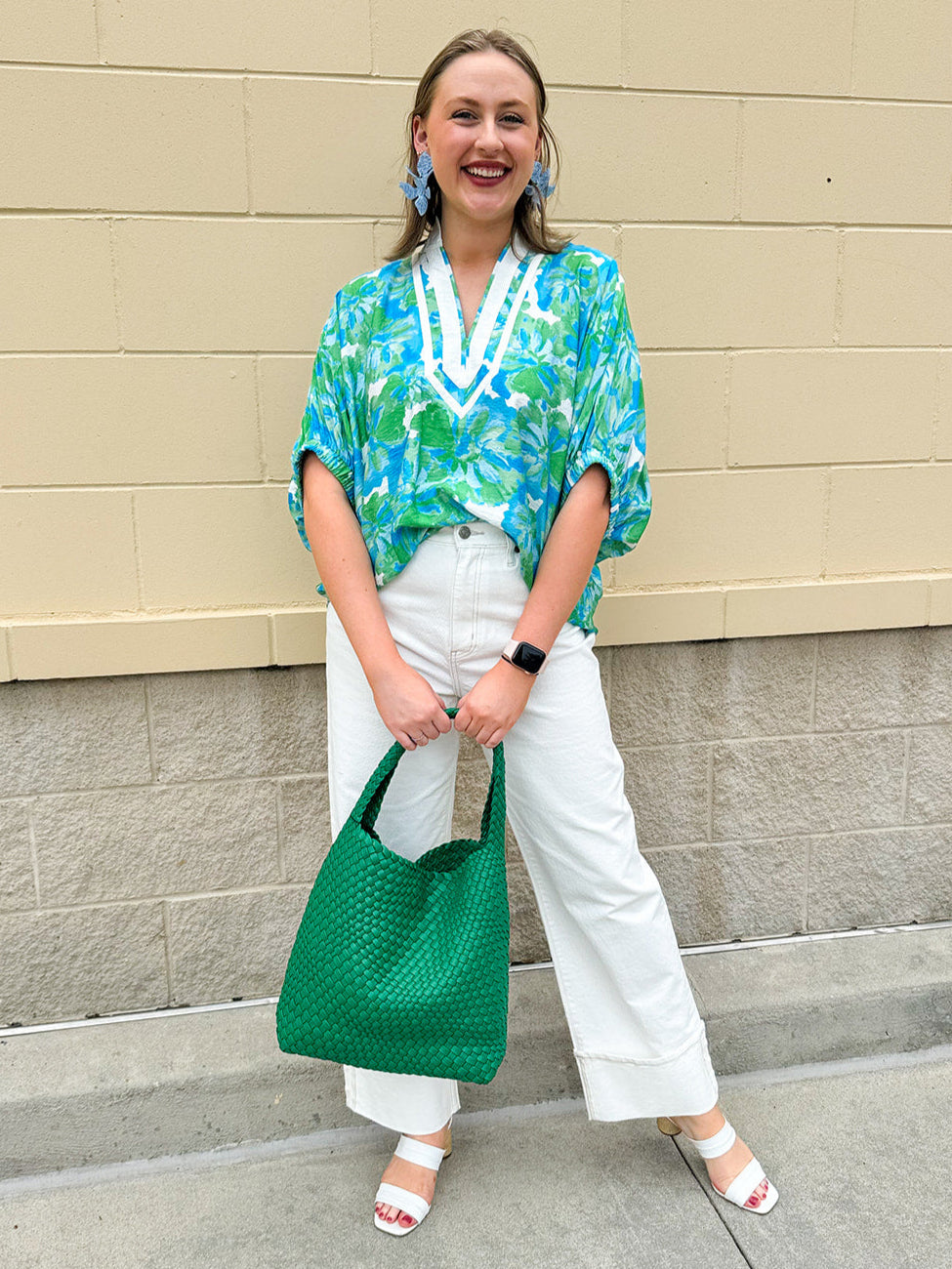 White caftan top with green and blue abstract floral print, split neckline, and dolman sleeves with elastic cuffs—lightweight and flowy