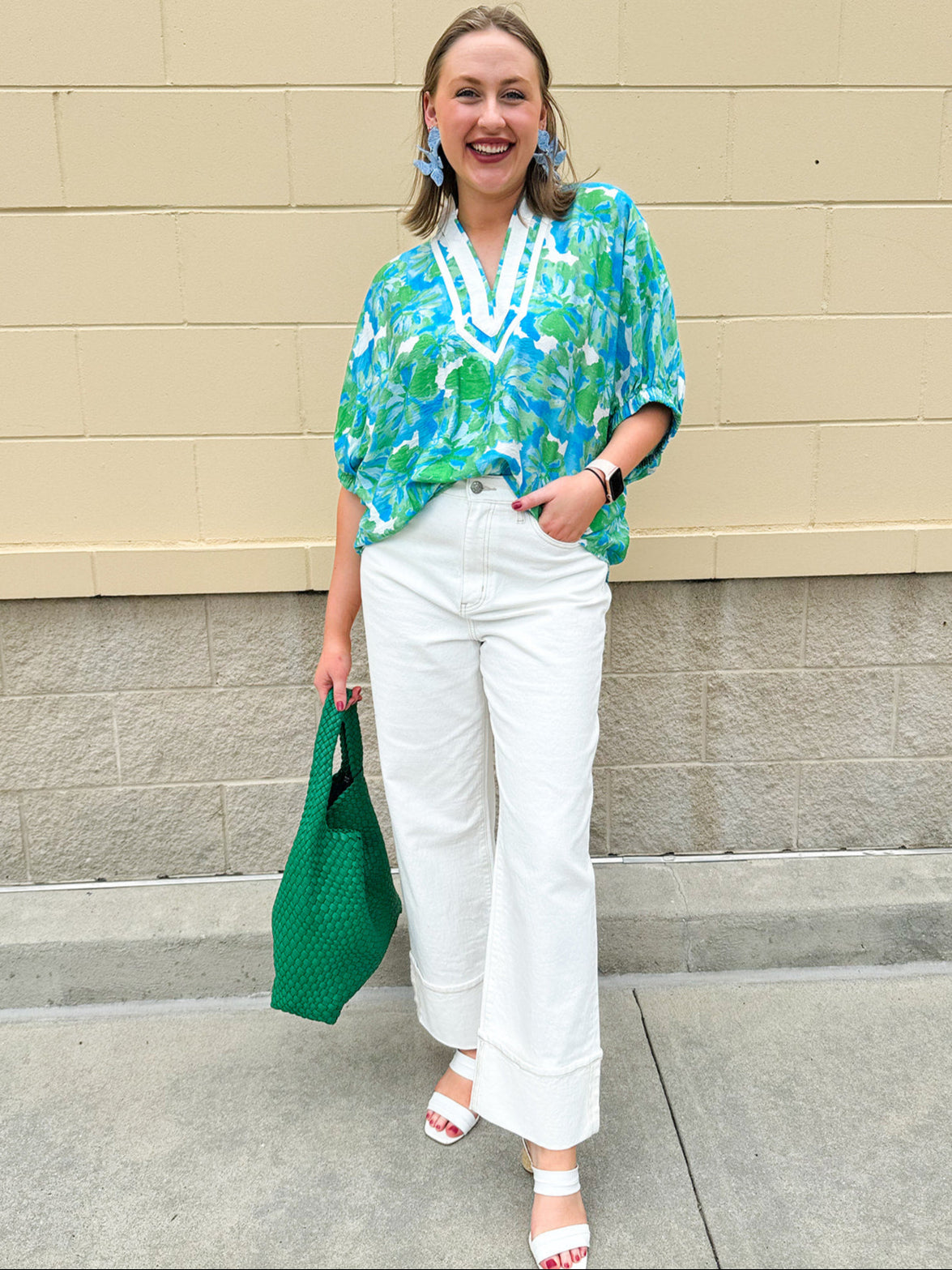 White caftan top with green and blue abstract floral print, split neckline, and dolman sleeves with elastic cuffs—lightweight and flowy