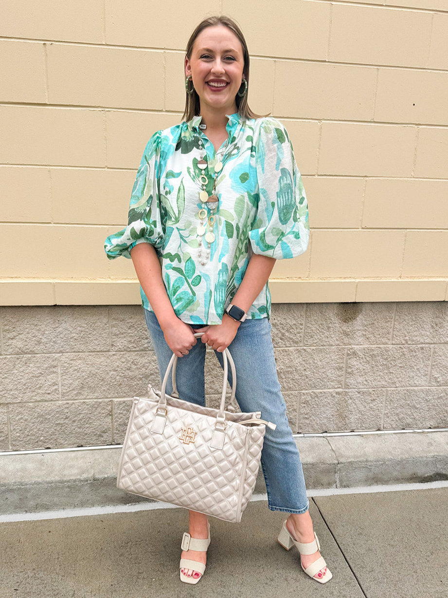 Cream and blue-green printed blouse with long sleeves, split neckline, scalloped ricrac hem, and flowy lightweight fabric