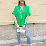 Kelly green blouse with frilled V-neckline, short dolman sleeves, and banded cuffs—bright, stylish, and feminine.