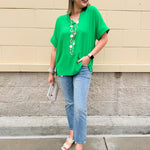 Kelly green blouse with frilled V-neckline, short dolman sleeves, and banded cuffs—bright, stylish, and feminine.