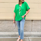Kelly green blouse with frilled V-neckline, short dolman sleeves, and banded cuffs—bright, stylish, and feminine.
