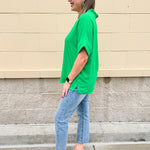 Kelly green blouse with frilled V-neckline, short dolman sleeves, and banded cuffs—bright, stylish, and feminine.