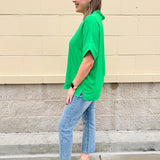 Kelly green blouse with frilled V-neckline, short dolman sleeves, and banded cuffs—bright, stylish, and feminine.