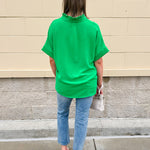 Kelly green blouse with frilled V-neckline, short dolman sleeves, and banded cuffs—bright, stylish, and feminine.