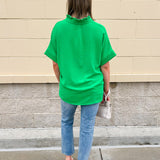 Kelly green blouse with frilled V-neckline, short dolman sleeves, and banded cuffs—bright, stylish, and feminine.