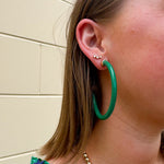 Kelly green acrylic hoop earrings with 2-inch diameter—lightweight and bold statement accessory
