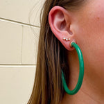 Kelly green acrylic hoop earrings with 2-inch diameter—lightweight and bold statement accessory