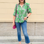 Green and pink paisley print blouse with frilled tie neckline and three-quarter peasant sleeves displayed on hanger against a neutral background
