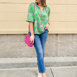 Green and pink paisley print blouse with frilled tie neckline and three-quarter peasant sleeves displayed on hanger against a neutral background