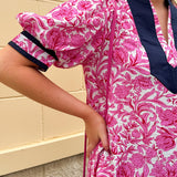 Pink caftan-style top with split neckline and botanical floral print, lightweight and relaxed fit