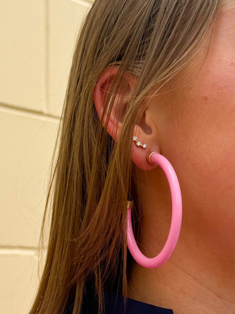 Bright pink 2-inch acrylic hoop earrings—lightweight and bold, perfect for adding a fun pop of color.