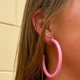 Bright pink 2-inch acrylic hoop earrings—lightweight and bold, perfect for adding a fun pop of color.